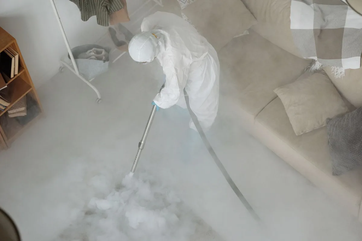 Biohazard cleanup technician in protective equipment, Ashbury Heights, San Francisco, CA